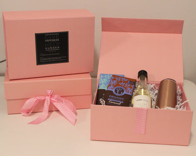 Pink gift box containing two Equal Exchange chocolate bars, mini ONEHOPE Brut and a stemless champagne flute tumbler